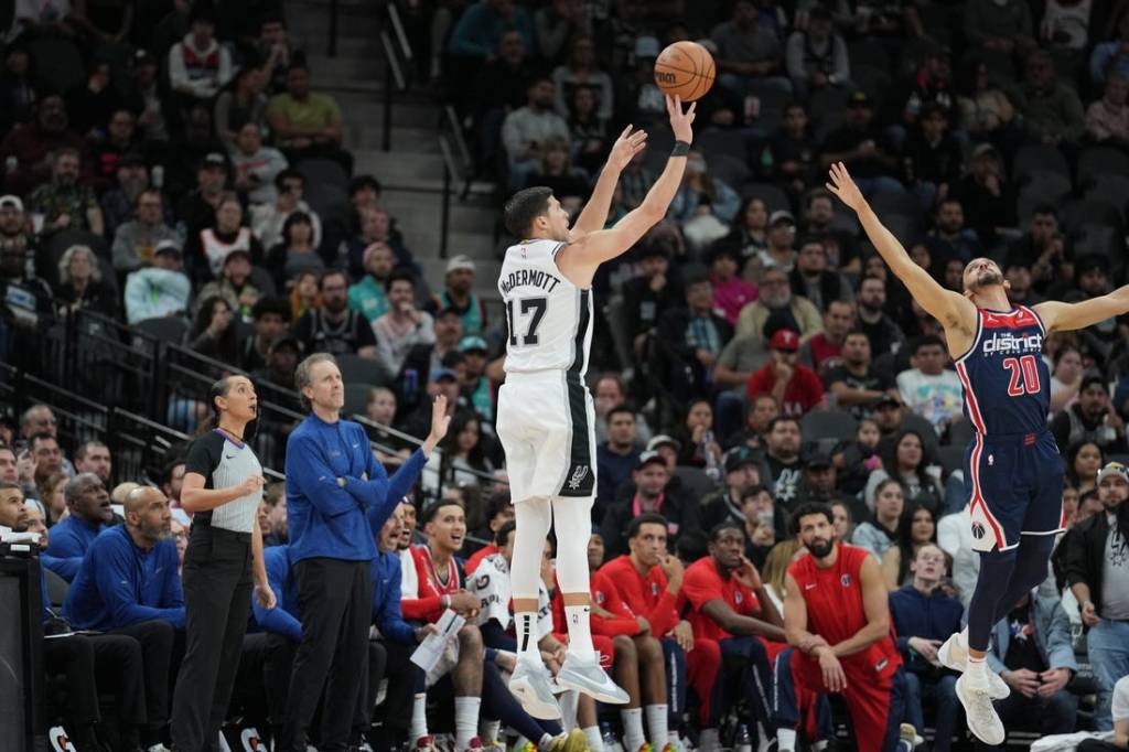 Jan 29, 2024; San Antonio, Texas, USA;  San Antonio Spurs forward Doug McDermott (17) shoots over Washington Wizards guard Landry Shamet (20) in the second half at Frost Bank Center. Mandatory Credit: Daniel Dunn-USA TODAY Sports