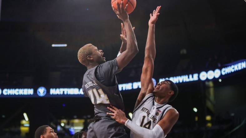 Jan 9, 2024; Atlanta, Georgia, USA; Georgia Tech Yellow Jackets guard Kowacie Reeves Jr. (14) shoots over Notre Dame Fighting Irish forward Kebba Njie (14) in the second half at McCamish Pavilion. Mandatory Credit: Brett Davis-USA TODAY Sports