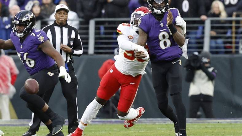 Jan 28, 2024; Baltimore, Maryland, USA; Kansas City Chiefs defensive end Charles Omenihu (90) strips the ball from Baltimore Ravens quarterback Lamar Jackson (8) in the AFC Championship football game at M&T Bank Stadium. Mandatory Credit: Geoff Burke-USA TODAY Sports