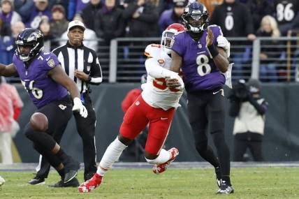 Jan 28, 2024; Baltimore, Maryland, USA; Kansas City Chiefs defensive end Charles Omenihu (90) strips the ball from Baltimore Ravens quarterback Lamar Jackson (8) in the AFC Championship football game at M&T Bank Stadium. Mandatory Credit: Geoff Burke-USA TODAY Sports