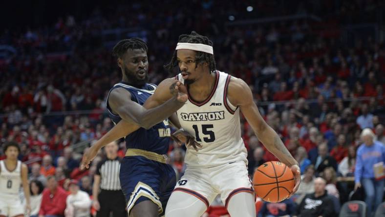 Jan 30, 2024; Dayton, Ohio, USA;  Dayton Flyers forward DaRon Holmes II (15) drives to the basket against George Washington center Babatunde Akingbola (23) during a game at University of Dayton Arena. Mandatory Credit: Matt Lunsford-USA TODAY Sports