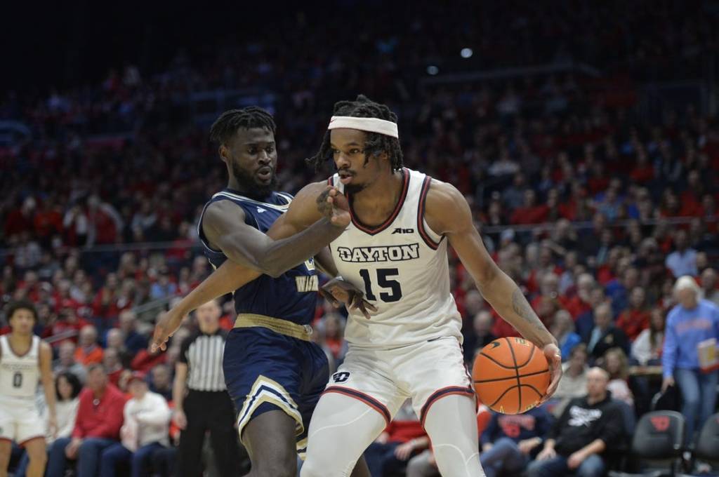 Jan 30, 2024; Dayton, Ohio, USA;  Dayton Flyers forward DaRon Holmes II (15) drives to the basket against George Washington center Babatunde Akingbola (23) during a game at University of Dayton Arena. Mandatory Credit: Matt Lunsford-USA TODAY Sports