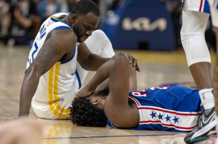 Jan 30, 2024; San Francisco, California, USA;  Golden State Warriors forward Draymond Green (23) checks on Philadelphia 76ers center Joel Embiid (21) after a play during the second quarter at Chase Center. Mandatory Credit: Neville E. Guard-USA TODAY Sports