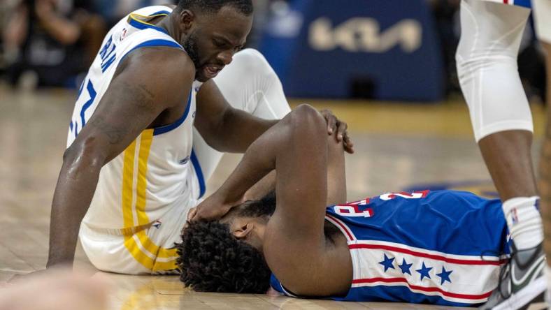 Jan 30, 2024; San Francisco, California, USA;  Golden State Warriors forward Draymond Green (23) checks on Philadelphia 76ers center Joel Embiid (21) after a play during the second quarter at Chase Center. Mandatory Credit: Neville E. Guard-USA TODAY Sports