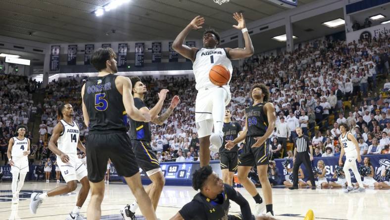 Jan 30, 2024; Logan, Utah, USA; Utah State Aggies forward Great Osobor (1) dunks the ball against the San Jose State Spartans during the second half at Dee Glen Smith Spectrum. Mandatory Credit: Rob Gray-USA TODAY Sports