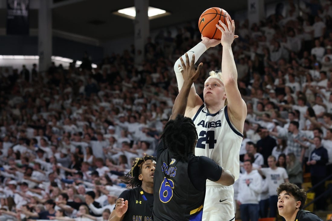 Jan 30, 2024; Logan, Utah, USA; Utah State Aggies forward Karson Templin (24) shoots over San Jose State Spartans guard Latrell Davis (6) during the second half at Dee Glen Smith Spectrum. Mandatory Credit: Rob Gray-USA TODAY Sports