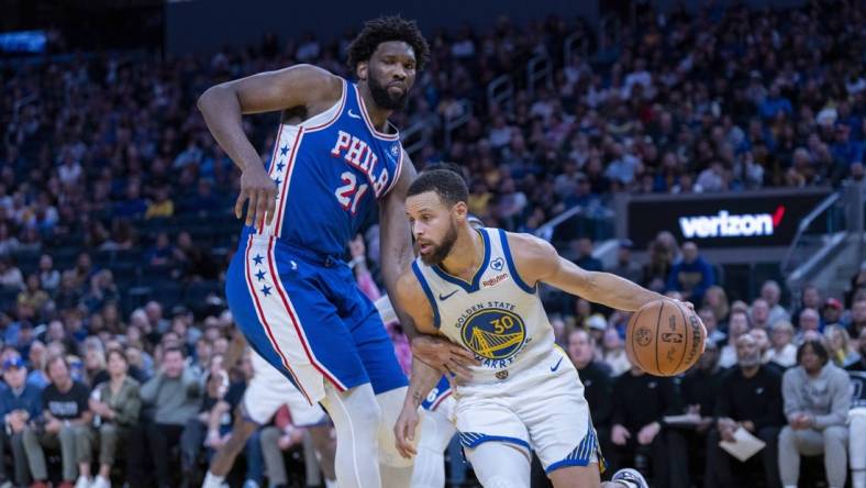 Jan 30, 2024; San Francisco, California, USA;  Golden State Warriors guard Stephen Curry (30) drives against Philadelphia 76ers center Joel Embiid (21) during the fourth quarter at Chase Center. Mandatory Credit: Neville E. Guard-USA TODAY Sports