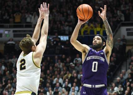 Jan 31, 2024; West Lafayette, Indiana, USA; Northwestern Wildcats guard Boo Buie (0) attempts a shot over Purdue Boilermakers guard Fletcher Loyer (2) during the first half at Mackey Arena. Mandatory Credit: Robert Goddin-USA TODAY Sports