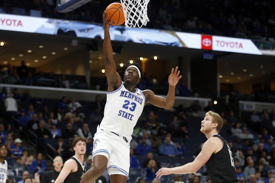 Jan 31, 2024; Memphis, Tennessee, USA; Memphis Tigers forward Malcolm Dandridge (23) drives to the basket as Rice Owls forward Max Fiedler (15) defends during the first half at FedExForum. Mandatory Credit: Petre Thomas-USA TODAY Sports