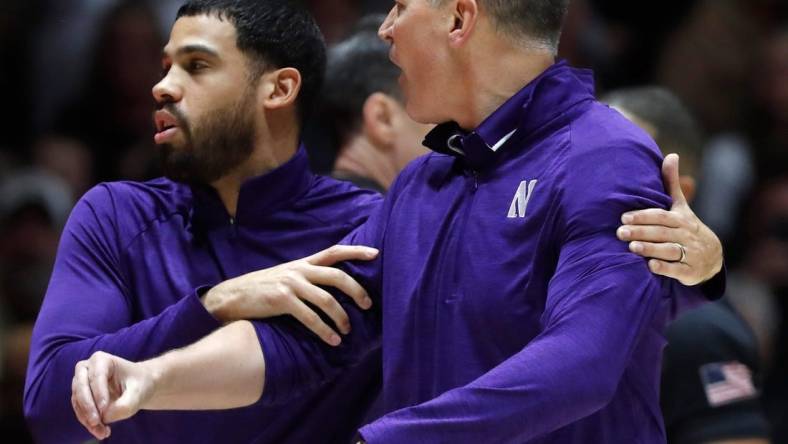 Northwestern Wildcats assistant coach Talor Battle holds back Northwestern Wildcats head coach Chris Collins during the NCAA men   s basketball game against the Purdue Boilermakers, Wednesday, Jan. 31, 2024, at Mackey Arena in West Lafayette, Ind. Purdue Boilermakers 105-96.