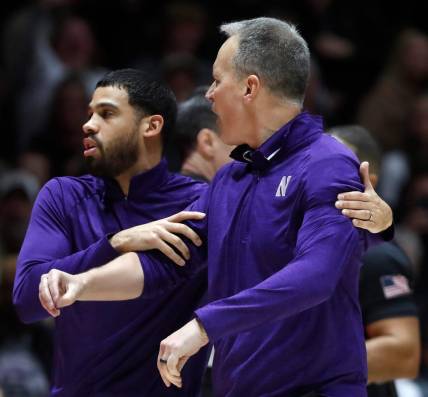 Northwestern Wildcats assistant coach Talor Battle holds back Northwestern Wildcats head coach Chris Collins during the NCAA men   s basketball game against the Purdue Boilermakers, Wednesday, Jan. 31, 2024, at Mackey Arena in West Lafayette, Ind. Purdue Boilermakers 105-96.