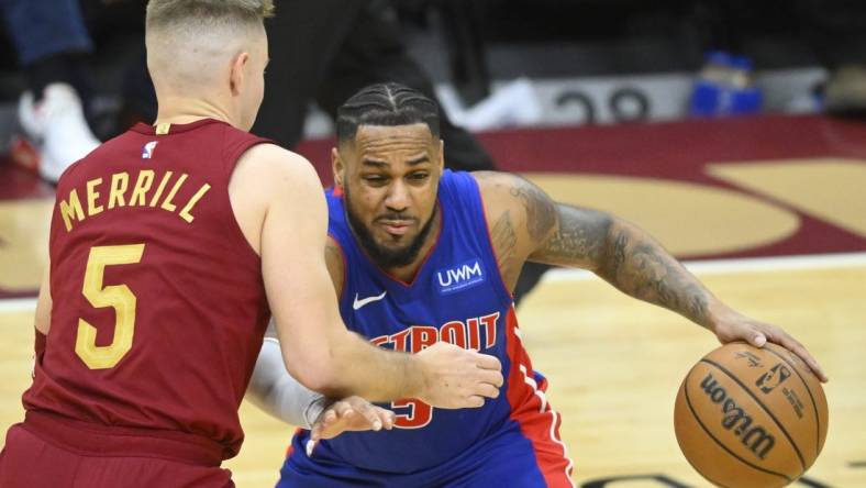 Jan 31, 2024; Cleveland, Ohio, USA; Cleveland Cavaliers guard Sam Merrill (5) defends Detroit Pistons guard Monte Morris (5) in the third quarter at Rocket Mortgage FieldHouse. Mandatory Credit: David Richard-USA TODAY Sports