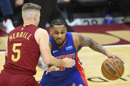 Jan 31, 2024; Cleveland, Ohio, USA; Cleveland Cavaliers guard Sam Merrill (5) defends Detroit Pistons guard Monte Morris (5) in the third quarter at Rocket Mortgage FieldHouse. Mandatory Credit: David Richard-USA TODAY Sports
