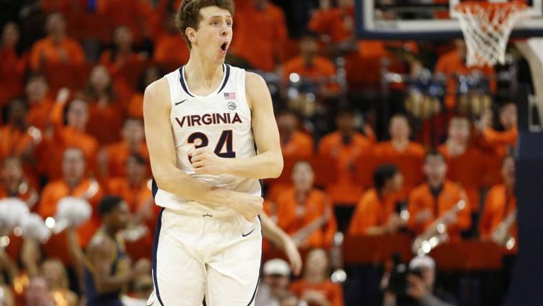 Jan 31, 2024; Charlottesville, Virginia, USA; Virginia Cavaliers forward Jacob Groves (34) celebrates after scoring against the Notre Dame Fighting Irish during the first half at John Paul Jones Arena. Mandatory Credit: Amber Searls-USA TODAY Sports