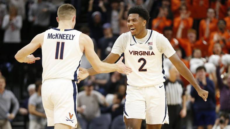 Jan 31, 2024; Charlottesville, Virginia, USA; Virginia Cavaliers guard Isaac McKneely (11) celebrates with Cavaliers guard Reece Beekman (2) after scoring against the Notre Dame Fighting Irish during the first half at John Paul Jones Arena. Mandatory Credit: Amber Searls-USA TODAY Sports