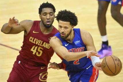 Jan 31, 2024; Cleveland, Ohio, USA; Detroit Pistons guard Cade Cunningham (2) throws a pass beside Cleveland Cavaliers guard Donovan Mitchell (45) in the fourth quarter at Rocket Mortgage FieldHouse. Mandatory Credit: David Richard-USA TODAY Sports