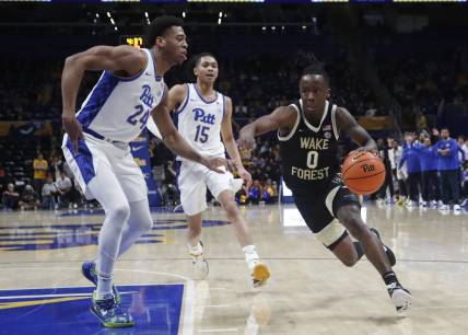 Jan 31, 2024; Pittsburgh, Pennsylvania, USA; Wake Forest Demon Deacons guard Kevin Miller (0) drives to the basket past Pittsburgh Panthers forward William Jeffress (24) and guard Jaland Lowe (15) during the second half at the Petersen Events Center. Pittsburgh won 77-72. Mandatory Credit: Charles LeClaire-USA TODAY Sports