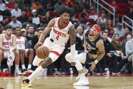 Jan 31, 2024; Houston, Texas, USA; New Orleans Pelicans guard Jose Alvarado (15) reacts as Houston Rockets guard Jalen Green (4) drives with the ball during the fourth quarter at Toyota Center. Mandatory Credit: Troy Taormina-USA TODAY Sports