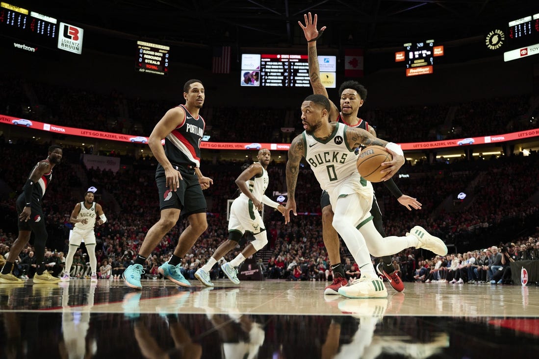 Jan 31, 2024; Portland, Oregon, USA; Milwaukee Bucks guard Damian Lillard (0) drives to the basket during the first half against Portland Trail Blazers guard Anfernee Simons (1) at Moda Center. Mandatory Credit: Troy Wayrynen-USA TODAY Sports