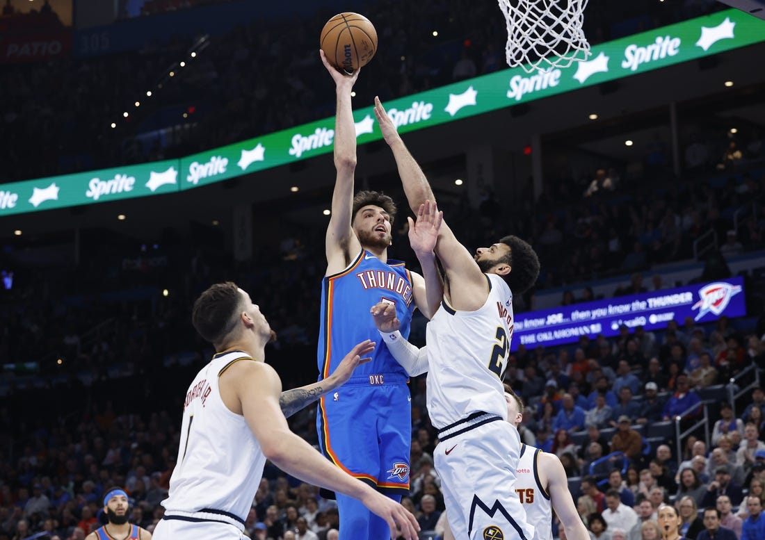 Jan 31, 2024; Oklahoma City, Oklahoma, USA; Oklahoma City Thunder forward Chet Holmgren (7) shoots as Denver Nuggets guard Jamal Murray (27) defends during the second half at Paycom Center. Mandatory Credit: Alonzo Adams-USA TODAY Sports