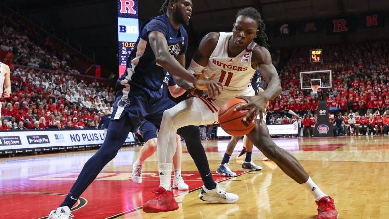 Jan 31, 2024; Piscataway, New Jersey, USA; Rutgers Scarlet Knights center Clifford Omoruyi (11) dribbles against Penn State Nittany Lions forward Qudus Wahab (22) during the second half at Jersey Mike's Arena. Mandatory Credit: Vincent Carchietta-USA TODAY Sports