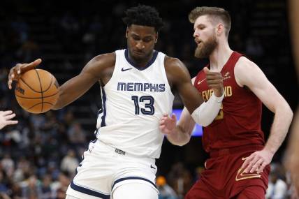 Feb 1, 2024; Memphis, Tennessee, USA; Memphis Grizzlies forward-center Jaren Jackson Jr. (13) drives to the basket as Cleveland Cavaliers forward Dean Wade (32) defends during the second half at FedExForum. Mandatory Credit: Petre Thomas-USA TODAY Sports