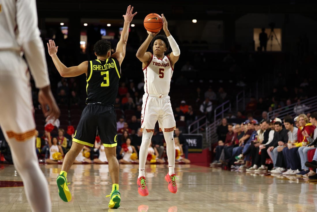 Feb 1, 2024; Los Angeles, California, USA; USC Trojans guard Boogie Ellis (5) shoots the ball over Oregon Ducks guard Jackson Shelstad (3) during the first half at Galen Center. Mandatory Credit: Kiyoshi Mio-USA TODAY Sports