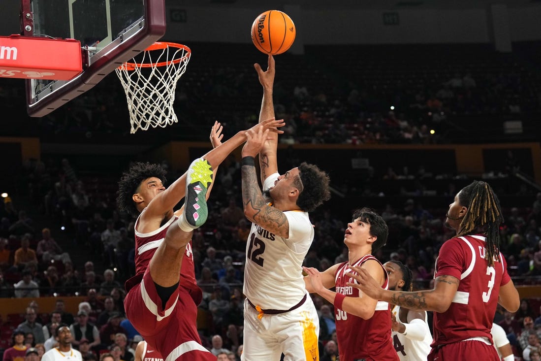 Feb 1, 2024; Tempe, Arizona, USA; Arizona State Sun Devils guard Jose Perez (12) shoots over Stanford Cardinal forward Spencer Jones (14) during the second half at Desert Financial Arena. Mandatory Credit: Joe Camporeale-USA TODAY Sports