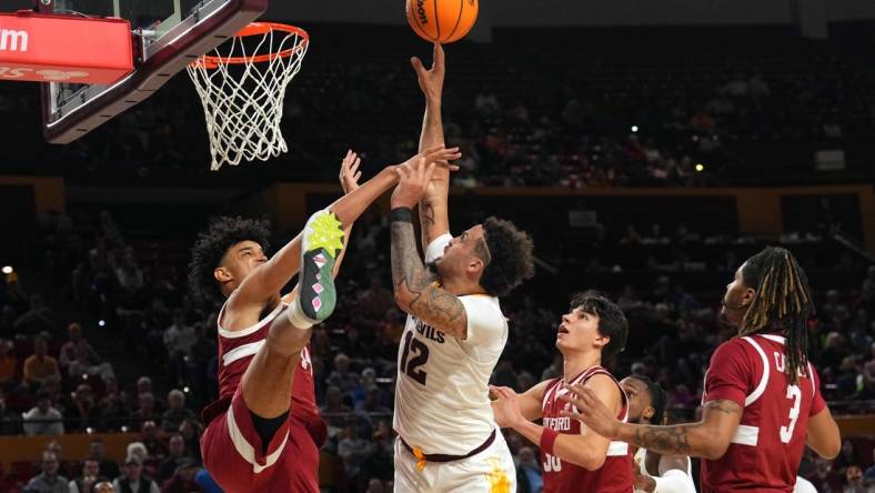 Feb 1, 2024; Tempe, Arizona, USA; Arizona State Sun Devils guard Jose Perez (12) shoots over Stanford Cardinal forward Spencer Jones (14) during the second half at Desert Financial Arena. Mandatory Credit: Joe Camporeale-USA TODAY Sports