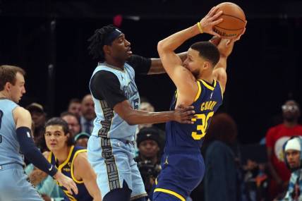 Feb 2, 2024; Memphis, Tennessee, USA; Golden State Warriors guard Stephen Curry (30) handles the ball as Memphis Grizzlies guard Vince Williams Jr. (5) defends during the first half at FedExForum. Mandatory Credit: Petre Thomas-USA TODAY Sports