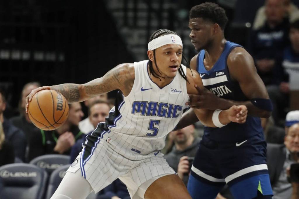 Feb 2, 2024; Minneapolis, Minnesota, USA; Orlando Magic forward Paolo Banchero (5) works around Minnesota Timberwolves guard Anthony Edwards (5) in the first quarter at Target Center. Mandatory Credit: Bruce Kluckhohn-USA TODAY Sports