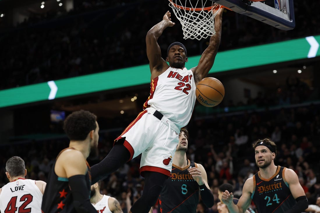 Feb 2, 2024; Washington, District of Columbia, USA; Miami Heat forward Jimmy Butler (22) dunks the ball as Washington Wizards forward Deni Avdija (8) looks on in the first half at Capital One Arena. Mandatory Credit: Geoff Burke-USA TODAY Sports