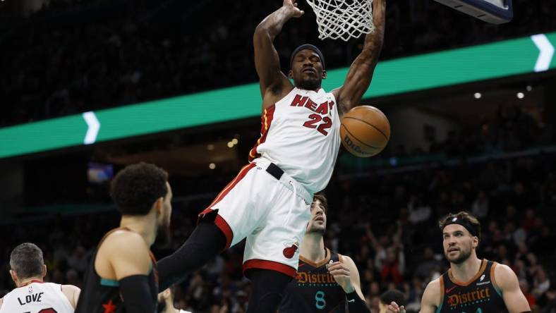 Feb 2, 2024; Washington, District of Columbia, USA; Miami Heat forward Jimmy Butler (22) dunks the ball as Washington Wizards forward Deni Avdija (8) looks on in the first half at Capital One Arena. Mandatory Credit: Geoff Burke-USA TODAY Sports