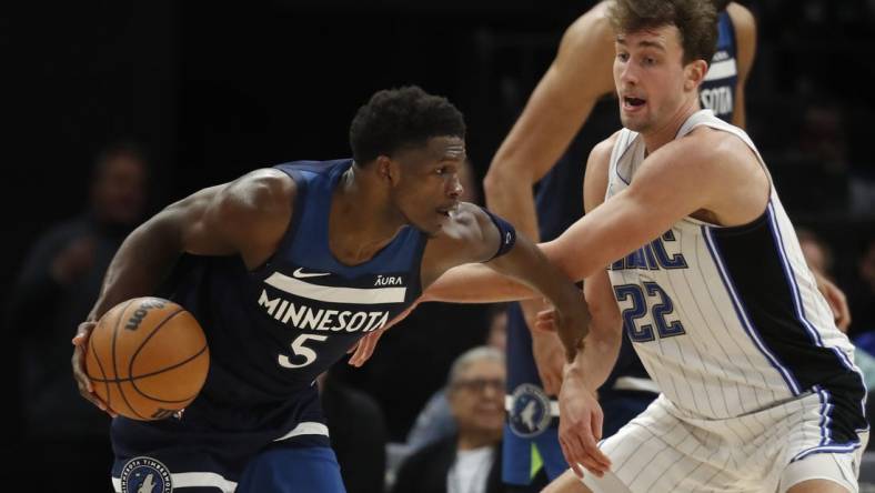 Feb 2, 2024; Minneapolis, Minnesota, USA; Minnesota Timberwolves guard Anthony Edwards (5) works around Orlando Magic forward Franz Wagner (22) in the fourth quarter at Target Center. Mandatory Credit: Bruce Kluckhohn-USA TODAY Sports