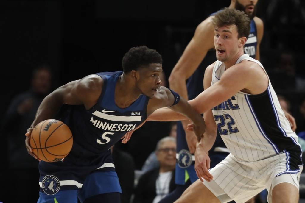 Feb 2, 2024; Minneapolis, Minnesota, USA; Minnesota Timberwolves guard Anthony Edwards (5) works around Orlando Magic forward Franz Wagner (22) in the fourth quarter at Target Center. Mandatory Credit: Bruce Kluckhohn-USA TODAY Sports