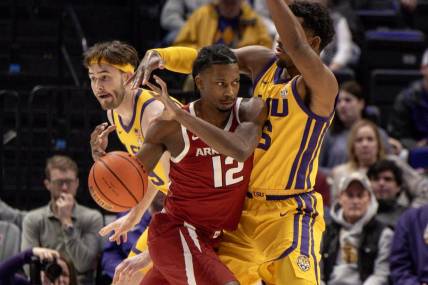 Feb 3, 2024; Baton Rouge, Louisiana, USA;  Arkansas Razorbacks guard Tramon Mark (12) dribbles into LSU Tigers guard Jordan Wright (6) to get to the basket during the first half at Pete Maravich Assembly Center. Mandatory Credit: Stephen Lew-USA TODAY Sports