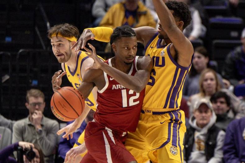 Feb 3, 2024; Baton Rouge, Louisiana, USA;  Arkansas Razorbacks guard Tramon Mark (12) dribbles into LSU Tigers guard Jordan Wright (6) to get to the basket during the first half at Pete Maravich Assembly Center. Mandatory Credit: Stephen Lew-USA TODAY Sports