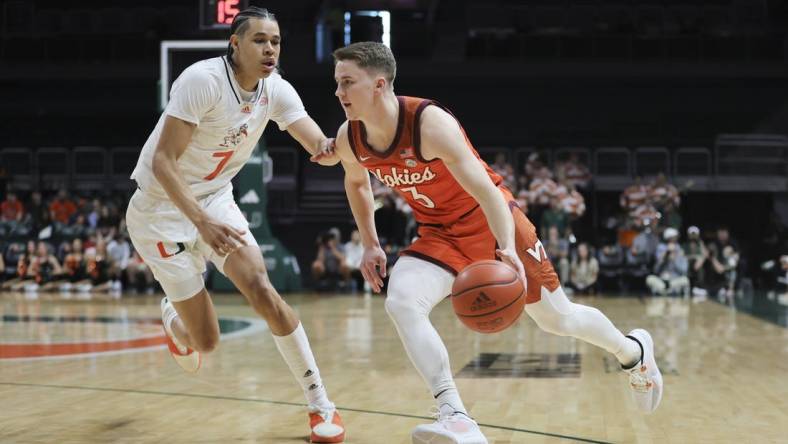 Feb 3, 2024; Coral Gables, Florida, USA; Virginia Tech Hokies guard Sean Pedulla (3) drives to the basket past Miami Hurricanes guard Kyshawn George (7) during the first half at Watsco Center. Mandatory Credit: Sam Navarro-USA TODAY Sports