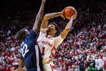 Feb 3, 2024; Bloomington, Indiana, USA; Indiana Hoosiers center Kel'el Ware (1) shoots the ball while Penn State Nittany Lions forward Qudus Wahab (22) defends in the first half at Simon Skjodt Assembly Hall. Mandatory Credit: Trevor Ruszkowski-USA TODAY Sports