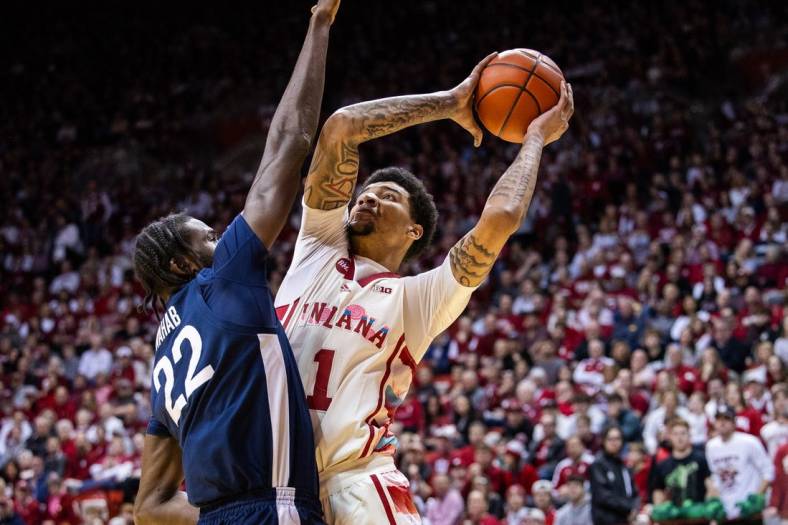 Feb 3, 2024; Bloomington, Indiana, USA; Indiana Hoosiers center Kel'el Ware (1) shoots the ball while Penn State Nittany Lions forward Qudus Wahab (22) defends in the first half at Simon Skjodt Assembly Hall. Mandatory Credit: Trevor Ruszkowski-USA TODAY Sports