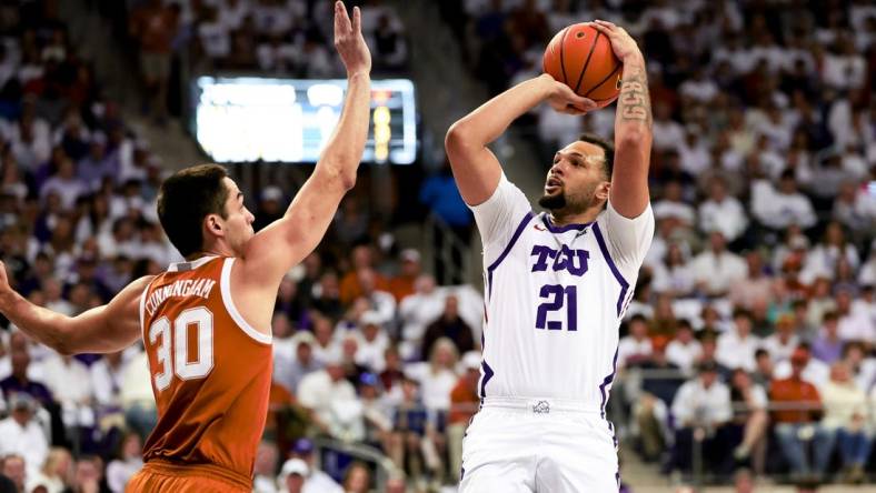 Feb 3, 2024; Fort Worth, Texas, USA;  TCU Horned Frogs forward JaKobe Coles (21) shoots over Texas Longhorns forward Brock Cunningham (30) during the first half at Ed and Rae Schollmaier Arena. Mandatory Credit: Kevin Jairaj-USA TODAY Sports