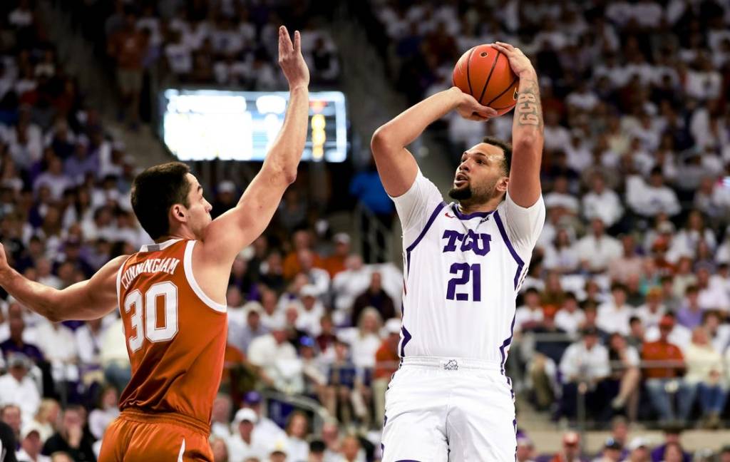 Feb 3, 2024; Fort Worth, Texas, USA;  TCU Horned Frogs forward JaKobe Coles (21) shoots over Texas Longhorns forward Brock Cunningham (30) during the first half at Ed and Rae Schollmaier Arena. Mandatory Credit: Kevin Jairaj-USA TODAY Sports