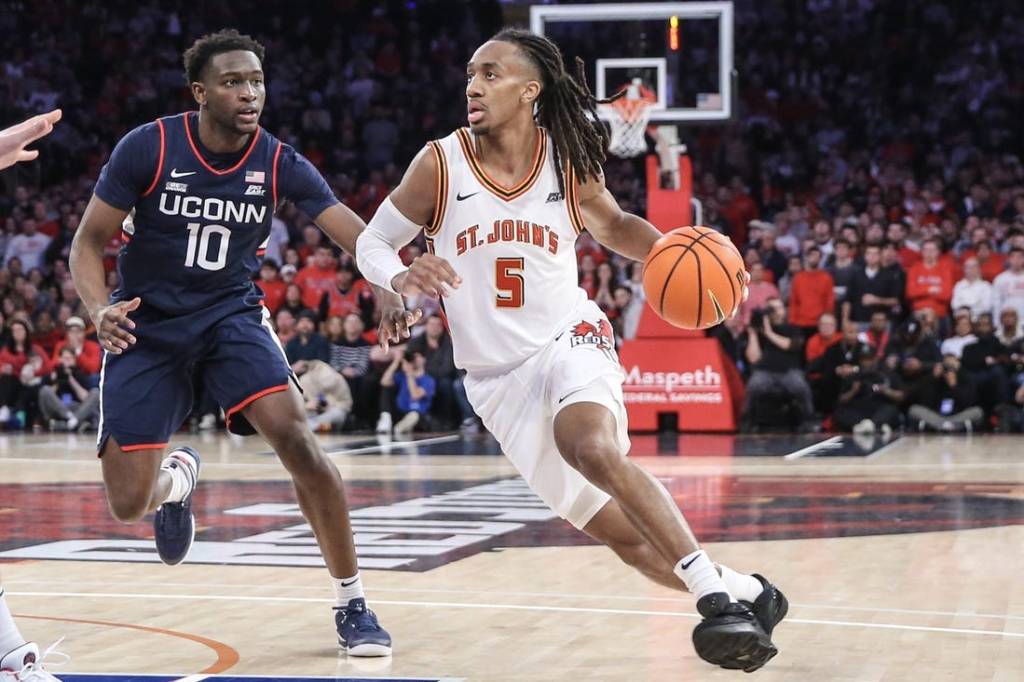 Feb 3, 2024; New York, New York, USA;  St. John's Red Storm guard Daniss Jenkins (5) drives past Connecticut Huskies guard Hassan Diarra (10) in the second half at Madison Square Garden. Mandatory Credit: Wendell Cruz-USA TODAY Sports