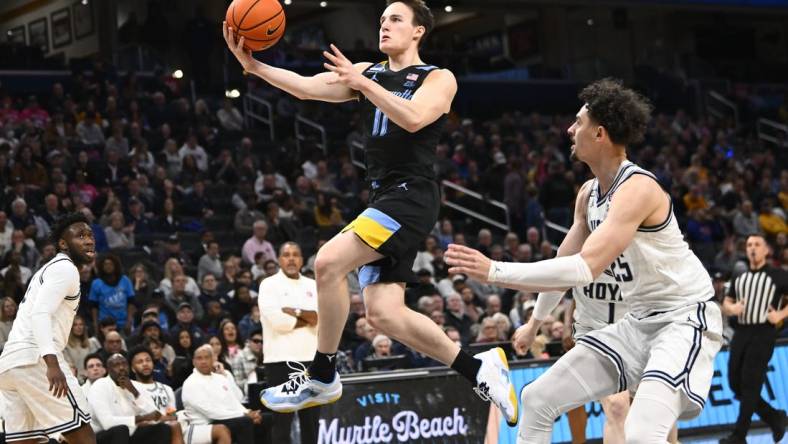 Feb 3, 2024; Washington, District of Columbia, USA; Marquette Golden Eagles guard Tyler Kolek (11) shoots past Georgetown Hoyas forward Ismael Massoud (25) during the first half at Capital One Arena. Mandatory Credit: Brad Mills-USA TODAY Sports