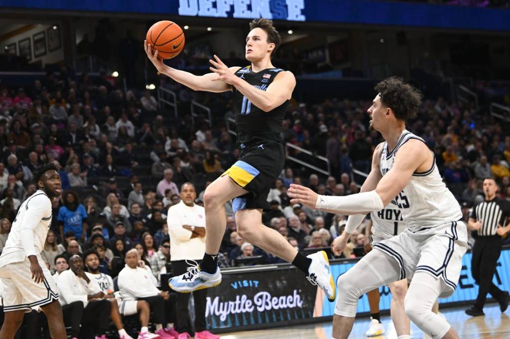 Feb 3, 2024; Washington, District of Columbia, USA; Marquette Golden Eagles guard Tyler Kolek (11) shoots past Georgetown Hoyas forward Ismael Massoud (25) during the first half at Capital One Arena. Mandatory Credit: Brad Mills-USA TODAY Sports