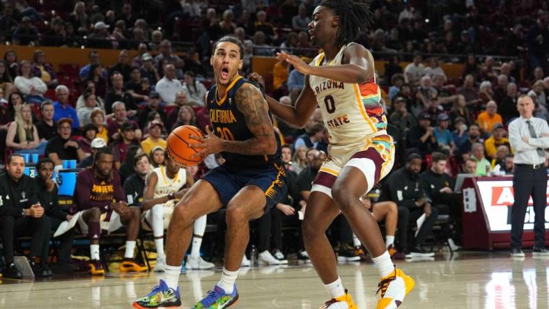 Feb 3, 2024; Tempe, Arizona, USA; California Golden Bears guard Jaylon Tyson (20) drives against Arizona State Sun Devils guard Kamari Lands (0) during the first half at Desert Financial Arena. Mandatory Credit: Joe Camporeale-USA TODAY Sports