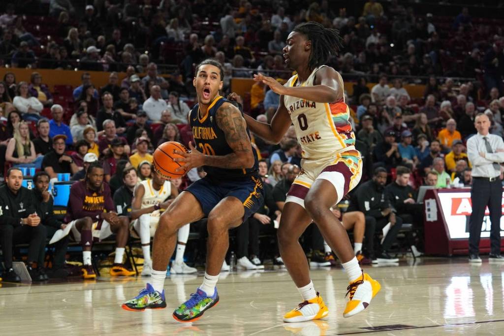 Feb 3, 2024; Tempe, Arizona, USA; California Golden Bears guard Jaylon Tyson (20) drives against Arizona State Sun Devils guard Kamari Lands (0) during the first half at Desert Financial Arena. Mandatory Credit: Joe Camporeale-USA TODAY Sports