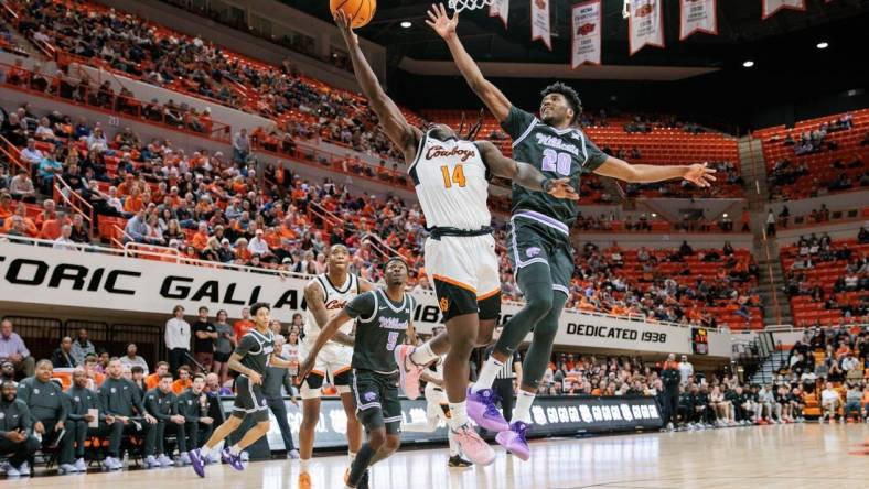 Feb 3, 2024; Stillwater, Oklahoma, USA; Oklahoma State Cowboys guard Jamyron Keller (14) shoots the ball around Kansas State Wildcats forward Jerrell Colbert (20) during the first half at Gallagher-Iba Arena. Mandatory Credit: William Purnell-USA TODAY Sports