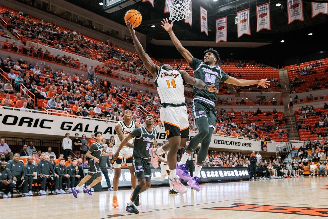 Feb 3, 2024; Stillwater, Oklahoma, USA; Oklahoma State Cowboys guard Jamyron Keller (14) shoots the ball around Kansas State Wildcats forward Jerrell Colbert (20) during the first half at Gallagher-Iba Arena. Mandatory Credit: William Purnell-USA TODAY Sports