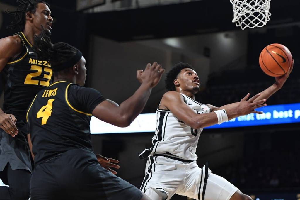 Feb 3, 2024; Nashville, Tennessee, USA; Vanderbilt Commodores guard Tyrin Lawrence (0) scores past Missouri Tigers forward Aidan Shaw (23) and guard Curt Lewis (4) during the first half at Memorial Gymnasium. Mandatory Credit: Christopher Hanewinckel-USA TODAY Sports